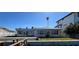 Backyard view featuring an outdoor patio, grassy area, and waterfront views at 16217 Redington Dr, Redington Beach, FL 33708