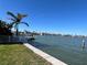 Lush backyard with waterfront access, a private dock, and well-maintained lawn at 16217 Redington Dr, Redington Beach, FL 33708
