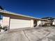 Exterior of this lovely home featuring an attached two-car garage and arched entryway at 16217 Redington Dr, Redington Beach, FL 33708