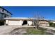 Charming single-story home featuring a neutral color palette, an arched entrance, and a two-car garage at 16217 Redington Dr, Redington Beach, FL 33708