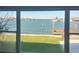 Scenic waterfront view from a window, featuring a beautiful lawn at 16217 Redington Dr, Redington Beach, FL 33708