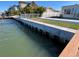 Reinforced waterfront with solid seawall, dock access, and manicured lawn at 16217 Redington Dr, Redington Beach, FL 33708