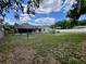 A large backyard featuring a pool, fenced perimeter, and green lawn at 1811 Tawnee Pl, Brandon, FL 33510