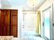 Bright bathroom featuring a shower-tub combo and wood cabinet doors at 1811 Tawnee Pl, Brandon, FL 33510