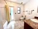 Bathroom with a bathtub, marble sink, and tile flooring at 1811 Tawnee Pl, Brandon, FL 33510