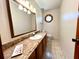 Cozy bathroom featuring vanity with granite counters and decorative round window at 1811 Tawnee Pl, Brandon, FL 33510