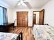Bedroom with a desk, closet, wood laminate floors, and two beds at 1811 Tawnee Pl, Brandon, FL 33510