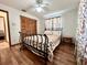 Comfortable bedroom featuring hardwood floors, a decorative bed frame, and closet providing great space at 1811 Tawnee Pl, Brandon, FL 33510