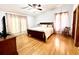 Bright bedroom features hardwood floors, ceiling fan, and natural light from two windows at 1811 Tawnee Pl, Brandon, FL 33510
