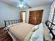 Cozy bedroom with ceiling fan, closet, wood laminate flooring and curtains at 1811 Tawnee Pl, Brandon, FL 33510