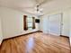 An empty bedroom with hardwood flooring, fan, window and sliding glass door at 1811 Tawnee Pl, Brandon, FL 33510