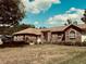 Charming single-story brick home with well-maintained landscaping and a sunny sky at 1811 Tawnee Pl, Brandon, FL 33510