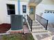 Inviting front entrance with decorative glass door, tiled steps, and black metal railings for a touch of elegance and safety at 1811 Tawnee Pl, Brandon, FL 33510