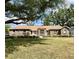Charming brick home featuring a lush front lawn, mature trees and a classic design at 1811 Tawnee Pl, Brandon, FL 33510