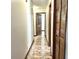 Hallway features tile flooring, wood doors and built-in storage at 1811 Tawnee Pl, Brandon, FL 33510