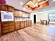 Bright kitchen showcasing wood cabinets, granite countertops, and wood-look floors at 1811 Tawnee Pl, Brandon, FL 33510
