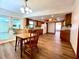 Open floor plan kitchen and dining area with wood floors, granite countertops, and a large window at 1811 Tawnee Pl, Brandon, FL 33510