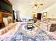 Spacious living room featuring a brick fireplace, a comfortable seating area, and lots of natural light at 1811 Tawnee Pl, Brandon, FL 33510