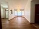 Inviting living room showcasing wood floors, large bay windows, and stylish chandelier at 1811 Tawnee Pl, Brandon, FL 33510
