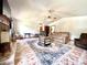 Bright living room with ceiling fan, rustic fireplace, and neutral paint at 1811 Tawnee Pl, Brandon, FL 33510