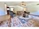 Open living room with vaulted ceilings, ceiling fan, and tan sofa at 1811 Tawnee Pl, Brandon, FL 33510