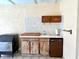 Outdoor kitchen with wood cabinets, sink, tile backsplash, ice maker, and tiled floor at 1811 Tawnee Pl, Brandon, FL 33510