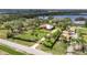 Stunning aerial view of a spacious property featuring a well-maintained lawn, mature trees, and private gated access at 2307 7Th Sw St, Ruskin, FL 33570