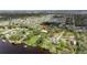 Expansive waterfront estate with mature trees, serene lake views, and access to a private dock, offering ultimate privacy at 2307 7Th Sw St, Ruskin, FL 33570