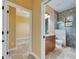 Bathroom with tile floor, wood cabinet vanity, decorative shower with a window and glass door at 2307 7Th Sw St, Ruskin, FL 33570