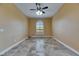 Neutral bedroom features tile flooring, a ceiling fan, and a window letting in plenty of natural light at 2307 7Th Sw St, Ruskin, FL 33570