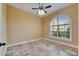 This bedroom features travertine flooring, ceiling fan and a semi-circular window at 2307 7Th Sw St, Ruskin, FL 33570