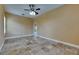 Bedroom with travertine flooring, ceiling fan and a view of the pool through a doorway at 2307 7Th Sw St, Ruskin, FL 33570