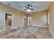 A bedroom with travertine floors, tan walls and ceiling fan, adjoins bath and closet at 2307 7Th Sw St, Ruskin, FL 33570
