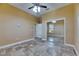 Bedroom featuring tile flooring, a ceiling fan, a window, and a mirrored closet at 2307 7Th Sw St, Ruskin, FL 33570