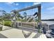 Boat docked on a boat lift overlooking the water, lush landscaping and a home in the background at 2307 7Th Sw St, Ruskin, FL 33570