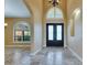 Inviting foyer featuring tile floors, an arched window, and a decorative chandelier at 2307 7Th Sw St, Ruskin, FL 33570
