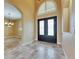 Spacious foyer with travertine tile floors, high ceilings, and arched doorways at 2307 7Th Sw St, Ruskin, FL 33570