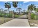 Gated estate entrance with stone pillars and decorative lighting providing privacy and security to this wonderful property at 2307 7Th Sw St, Ruskin, FL 33570