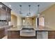 Kitchen with an island sink and stone countertops overlooking an open floor plan at 2307 7Th Sw St, Ruskin, FL 33570