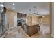 Spacious kitchen with stone floors, an island, stainless appliances, and breakfast bar at 2307 7Th Sw St, Ruskin, FL 33570