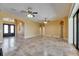 Open living area featuring travertine floors, arched doorways, and multiple ceiling fans at 2307 7Th Sw St, Ruskin, FL 33570