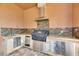 Close up of the built in grill, refrigeration and granite countertops of the outdoor kitchen at 2307 7Th Sw St, Ruskin, FL 33570