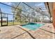 Screened in pool with brick pavers and view of the river beyond at 2307 7Th Sw St, Ruskin, FL 33570