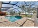 Beautiful screened in pool with outdoor kitchen, view of the river and lounge chair at 2307 7Th Sw St, Ruskin, FL 33570