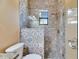 Shower with decorative blue and brown patterned tile, a frosted door, and a shower head at 2307 7Th Sw St, Ruskin, FL 33570