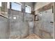 A large shower stall has stone walls and accent tiles plus a stone-tiled floor at 2307 7Th Sw St, Ruskin, FL 33570