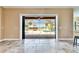 Open sliding glass doors with a view of a screened-in pool and yard at 2307 7Th Sw St, Ruskin, FL 33570