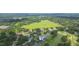 Aerial view of home near a golf course surrounded by lots of mature trees in a well-kept neighborhood at 2709 Fairway View Dr, Valrico, FL 33596