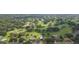 Aerial view of property with a sparkling pool, overlooking the manicured golf course and verdant landscape at 2709 Fairway View Dr, Valrico, FL 33596