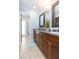 Beautiful bathroom boasts double vanity, wood cabinets, granite countertops, and recessed lighting at 2709 Fairway View Dr, Valrico, FL 33596